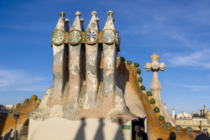 Spain, Catalonia, Barcelona, Eixample district, Passeig de Gracia, Casa Batllo by Catalan modernist architect Antoni Gaudi, UNESCO World Heritage site, chimneys, roof suggesting a dragon's spine and tower crowned with a ceramic spire surmounted by a typical Gaudi cross