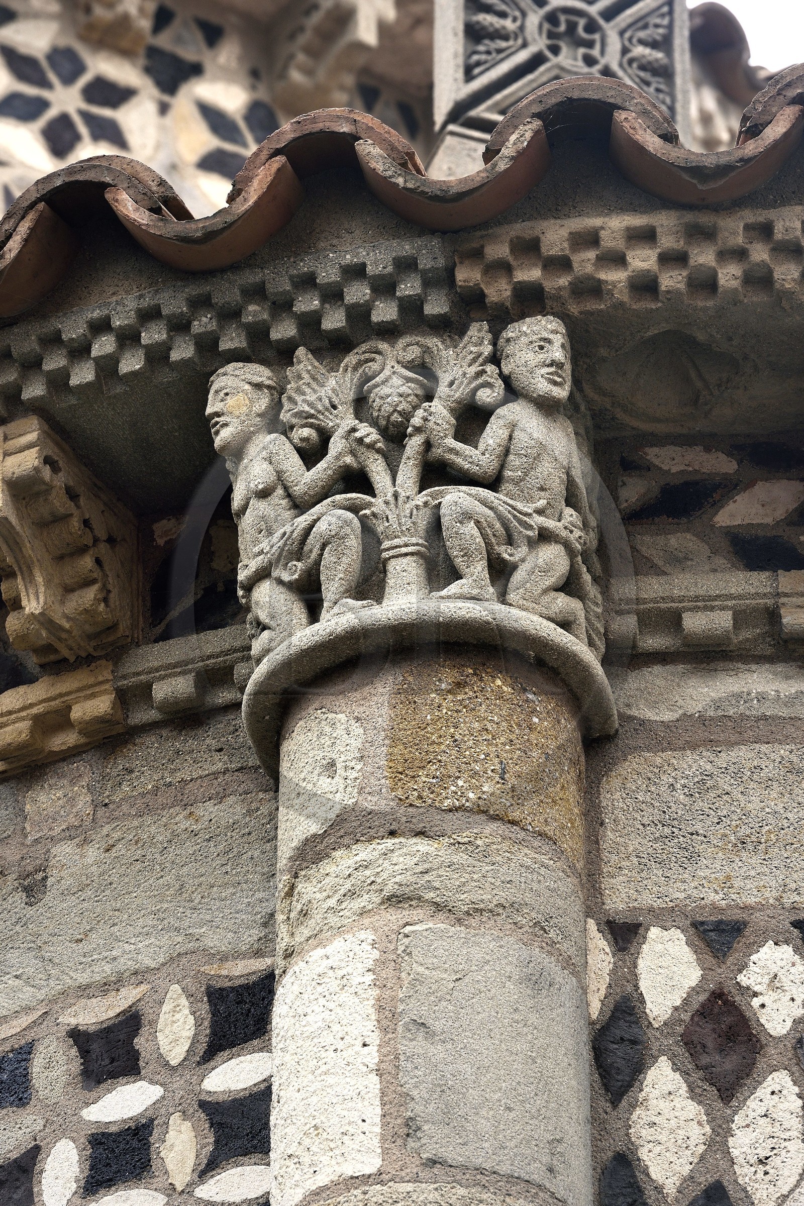 France, Puy de Dome, Clermont Ferrand, Notre-Dame-du-Port basilica in Auvergne Romanesque style, listed as a UNESCO World Heritage Site under the Routes of Saint-Jacques-de-Compostelle in France, apse of the church, capital representing Adam and Eve