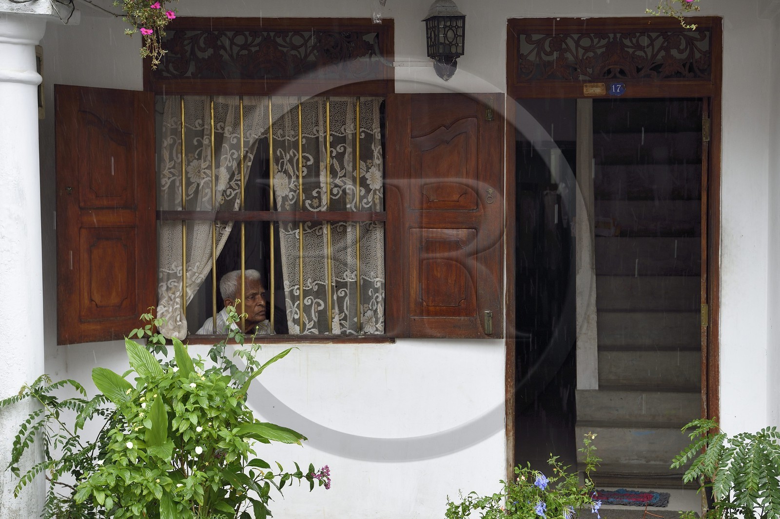 Sri Lanka, Southern Province, Galle Fort, listed as World heritage by UNESCO, old town house entrance, old man looking outside