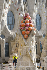 Spain, Catalonia, Barcelona, Eixample district, Sagrada Familia basilica by Catalan modernist architect Antoni Gaudi, listed as a UNESCO World Heritage Site, peak topped with mosaics in the shape of fruits
