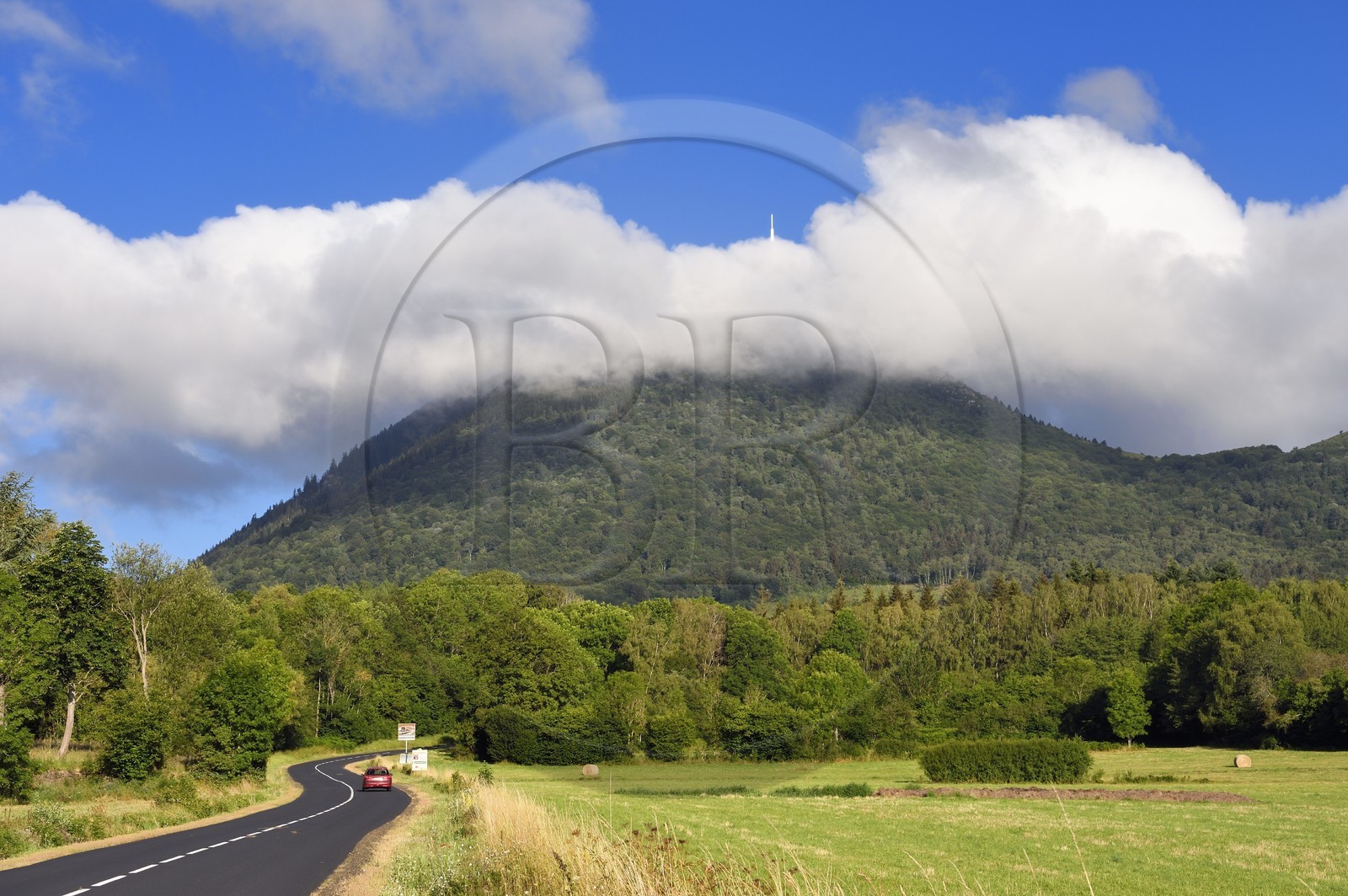 France, Puy de Dome, Parc Naturel Régional des Volcans d'Auvergne (regional nature park of Auvergne volcanoes), Chaine des Puys listed as World heritage by UNESCO, the Puy de Dôme volcano whose summit is in the clouds