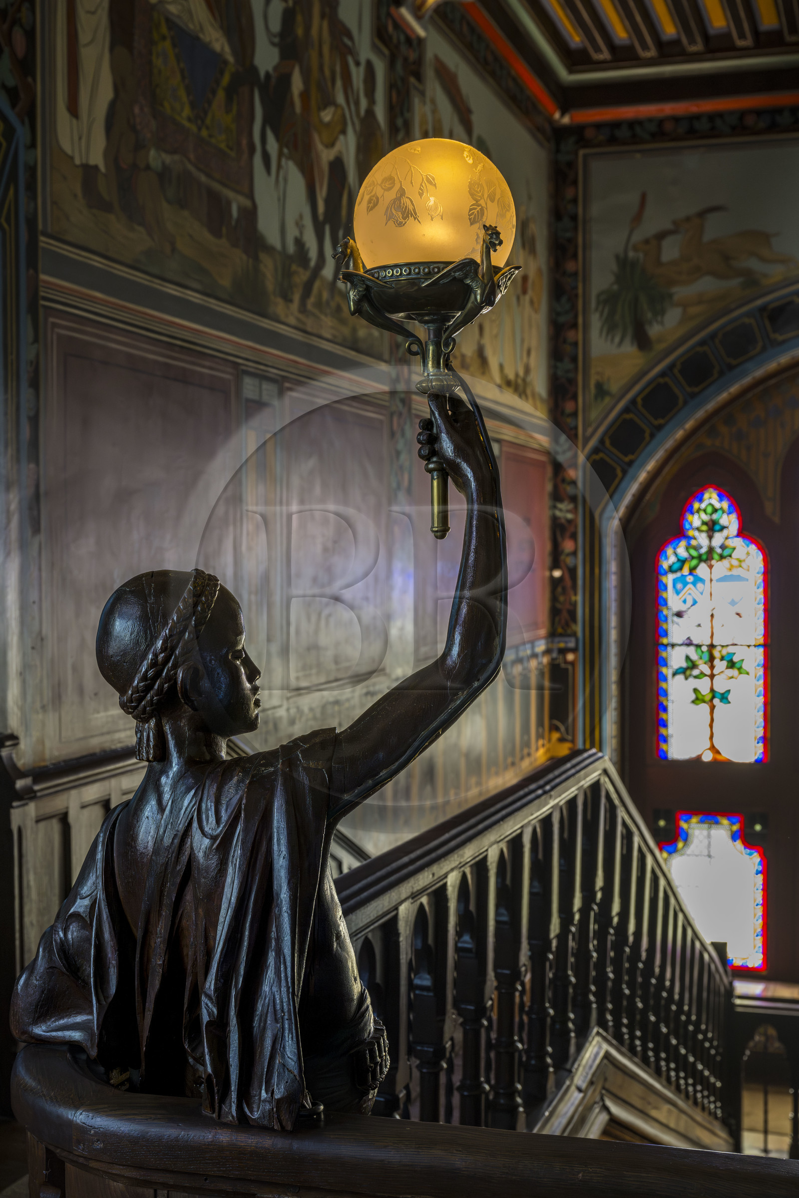 France, Pyrenees Atlantiques, Basque Country coast, Hendaye, Abbadia castle built in 1870 by Eugène Viollet-le-Duc for Antoine d'Abbadie d'Arrast, the grand staircase, torchiere lamp statue representing Abdullah former Ethiopian slave freed and dead under the commune of Paris