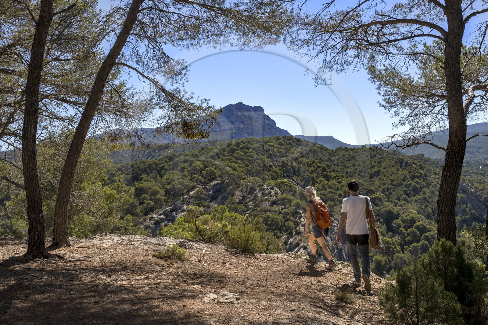 France, Bouches du Rhone, Aix en Provence, hikers on the Bibemus plateau and the Sainte Victoire mountain in the background