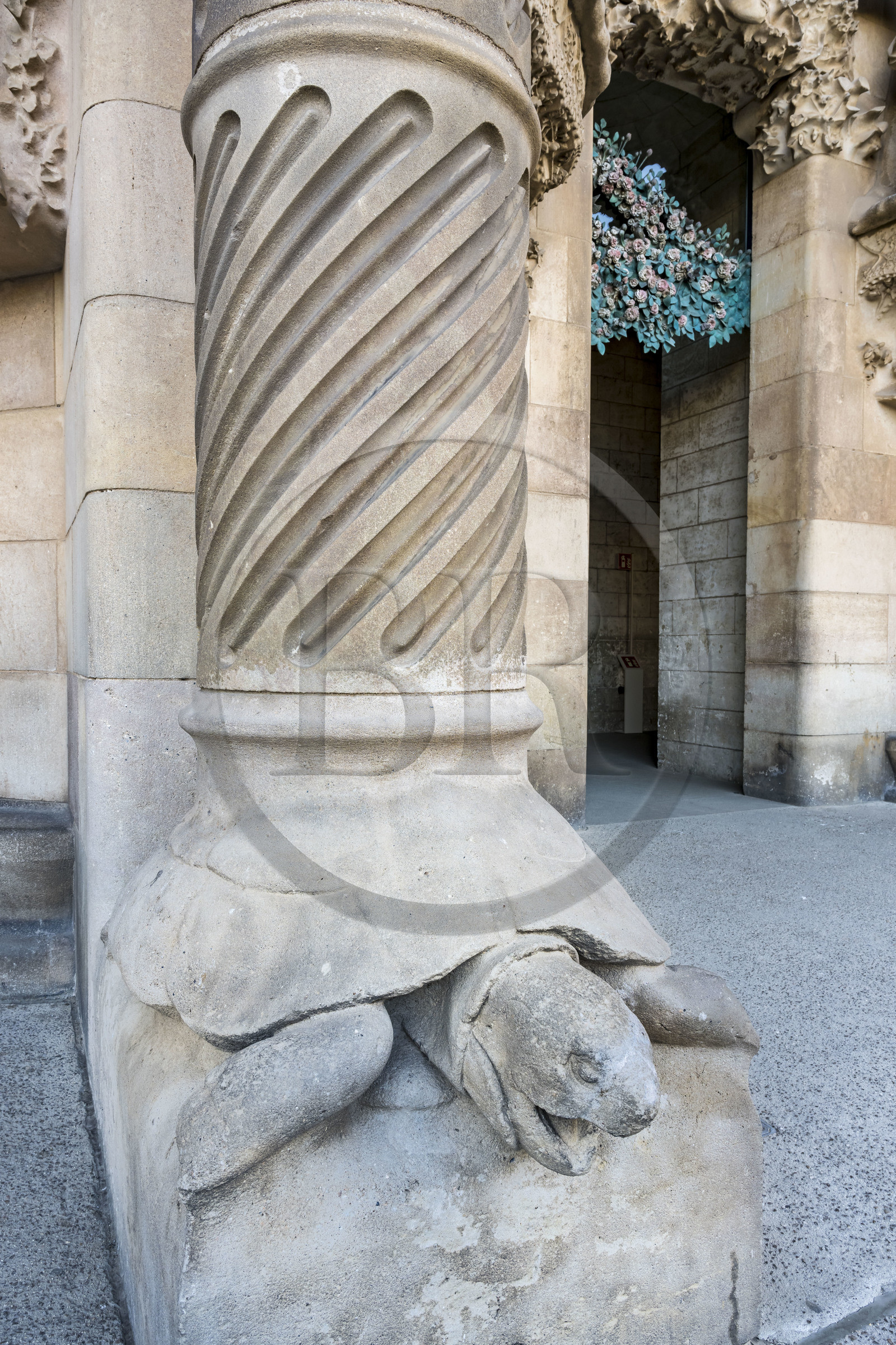 Spain, Catalonia, Barcelona, Eixample district, Sagrada Familia basilica by Catalan modernist architect Antoni Gaudi, listed as a UNESCO World Heritage Site, turtle supporting one of the columns of the Porte de la Charité