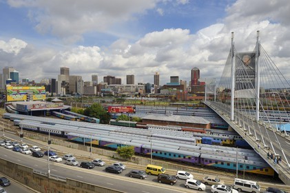 South Africa, Gauteng Province, Johannesburg, Nelson Mandela bridge over train carriages at Park Station and Johannesburg CBD (Central Business District) seen from the district of Braamfontein