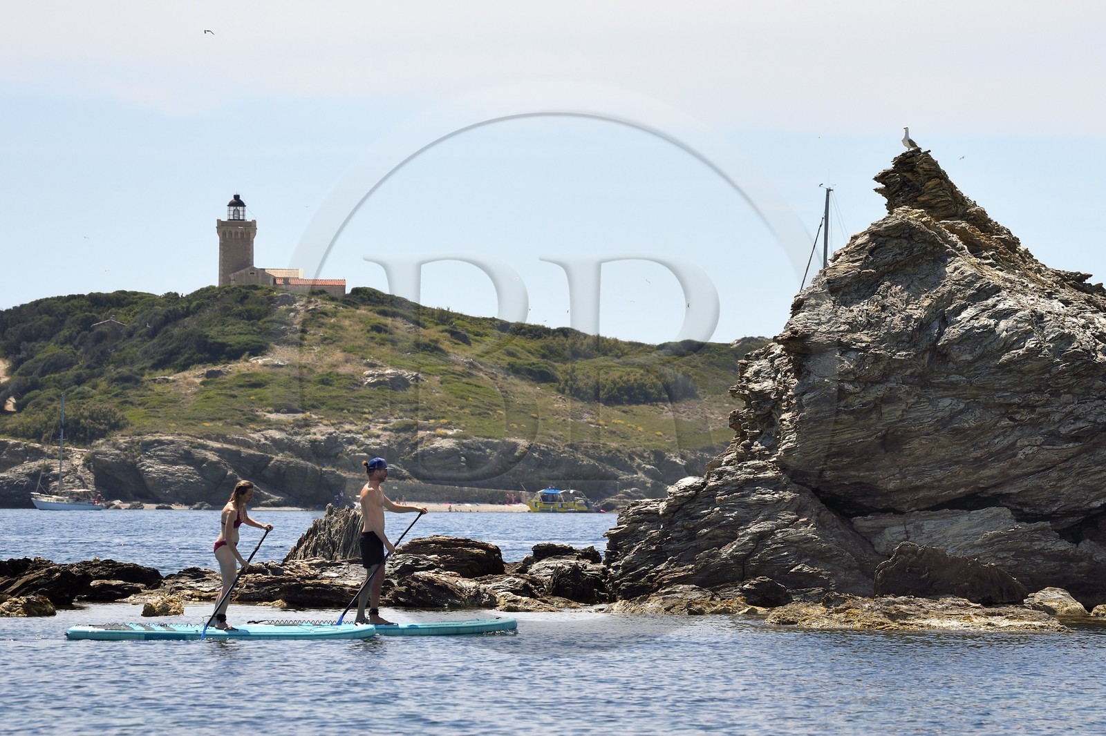 France, Var, Six Fours les Plages, Ile des Embiez, cape Saint Pierre, Freestyle windsurfing champion Adrien Bosson on a paddle boarding excursion, the Grand Rouveau lighthouse in the background