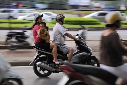 Vietnam, Hanoi, hazardous driving for a family on a motorbike