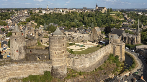 France, Ille-et-Vilaine, Fougeres, 12th century fortified castle and the Saint-Sulpice church, the Saint-Léonard church in the background (aerial view)