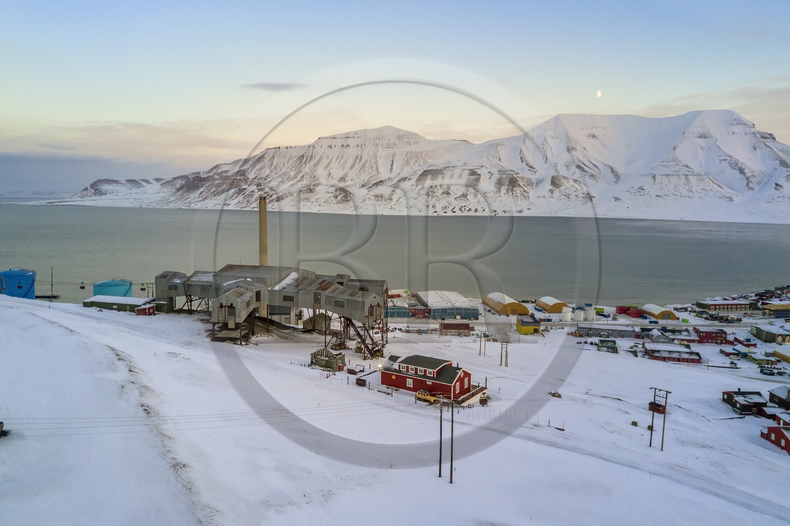 Norway, Svalbard, Spitzbergen, Longyearbyen, Taubanesentralen on the left, abandoned central cableway building used for transporting coal in carts from the mines to the harbour (aerial view)