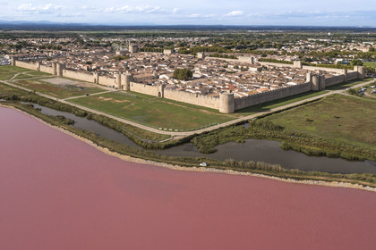 France, Gard, Aigues Mortes, the medieval town surrounded by its ramparts on the edge of the salt marshes (Salins du Midi) (aerial view)