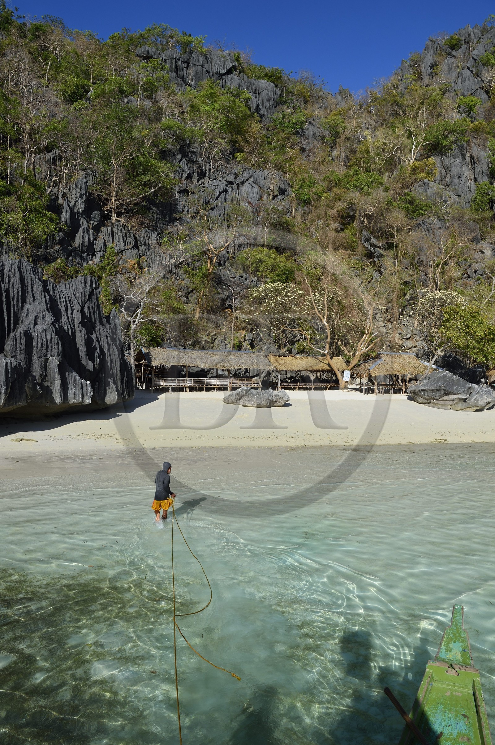 Philippines, Calamian Islands dans le nord de Palawan, Coron Island Natural Biotic Area, plage de Banul Beach au pied des murs géants des falaises de calcaire, batelier