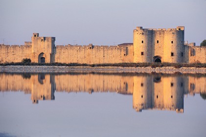 France, Gard, Aigues Mortes town, city walls behind the pond