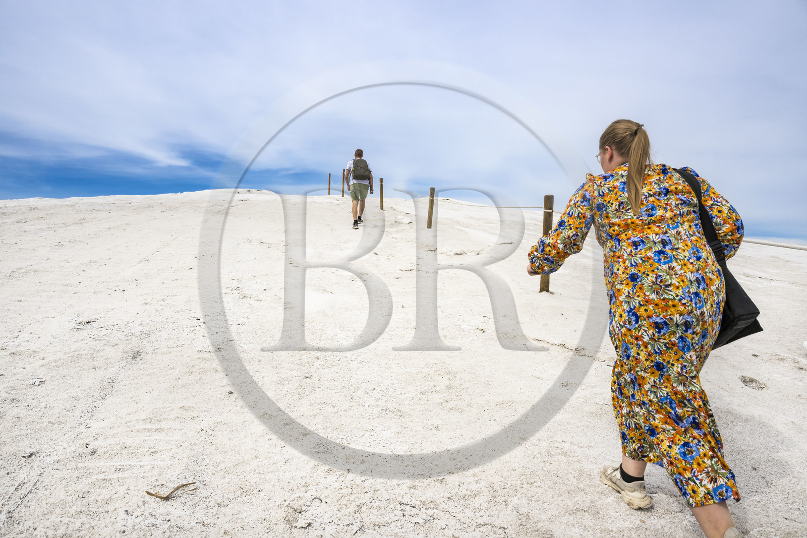 France, Gard, Aigues Mortes, the saline of Aigues-Mortes (Salins du Midi), tourists climbing on a salt mountain