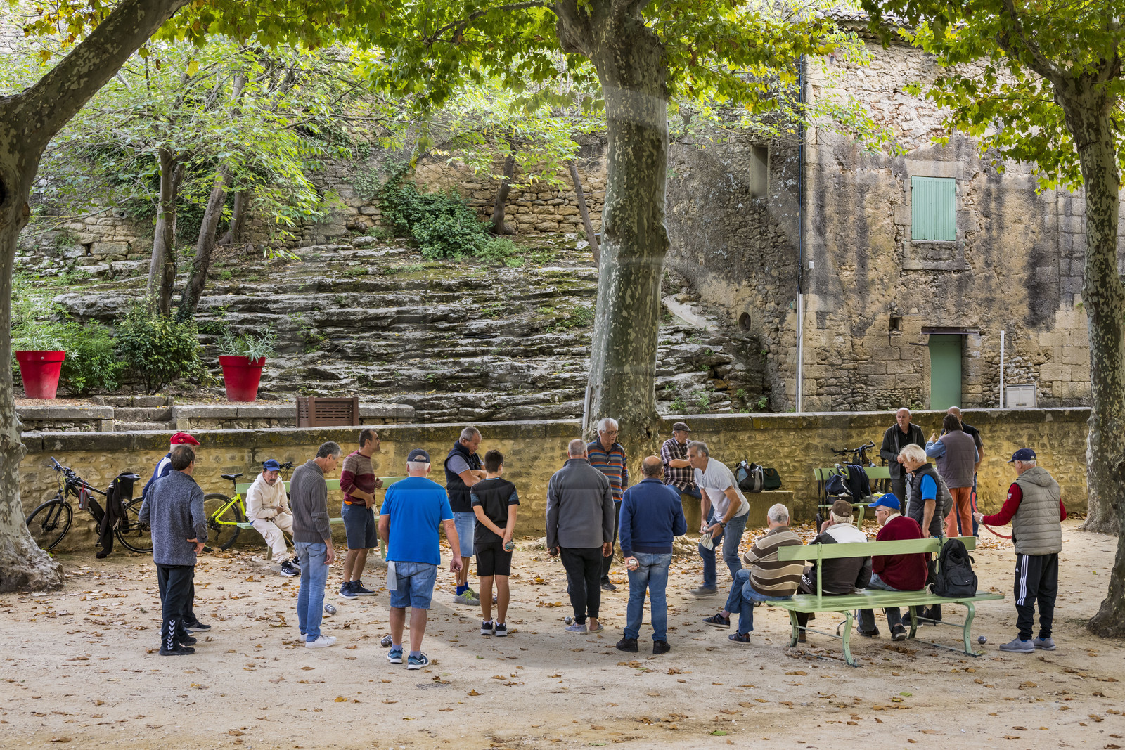France, Gard, Vers Pont du Gard, petanque players on the village square which is on the path along the route of the Roman aqueduct of Nimes