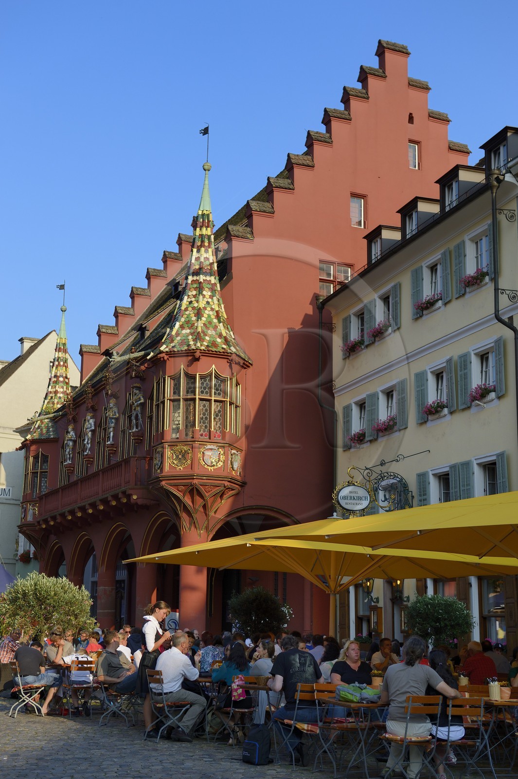 Germany, Baden-Wurttemberg, Freiburg im Breisgau, the Historical Merchants Hall of the early 16th century on the Munsterplatz and Terrace of the restaurant Oberkirch