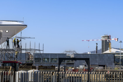 Spain, Catalonia, Barcelona, La Barceloneta, Port Vell, shipyard and the Christopher Columbus column in the background