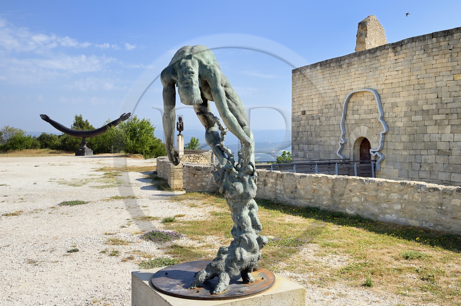 France, Vaucluse, Parc Naturel Regional du Luberon (Natural Regional Park of Luberon), Lourmarin, labelled Les Plus Beaux Villages de France (The Most Beautiful Villages of France), Lacoste, Lacoste castle, one of the residences of the Marquis de Sade and nowadays owned by Pierre Cardin, sculpture Tree of Life of the artist Ettore Greco in the foreground