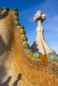 Spain, Catalonia, Barcelona, Eixample district, Passeig de Gracia, Casa Batllo by Catalan modernist architect Antoni Gaudi, UNESCO World Heritage site, roof suggesting the spine of the dragon and tower crowned with a ceramic spire topped with a typical Gaudi cross