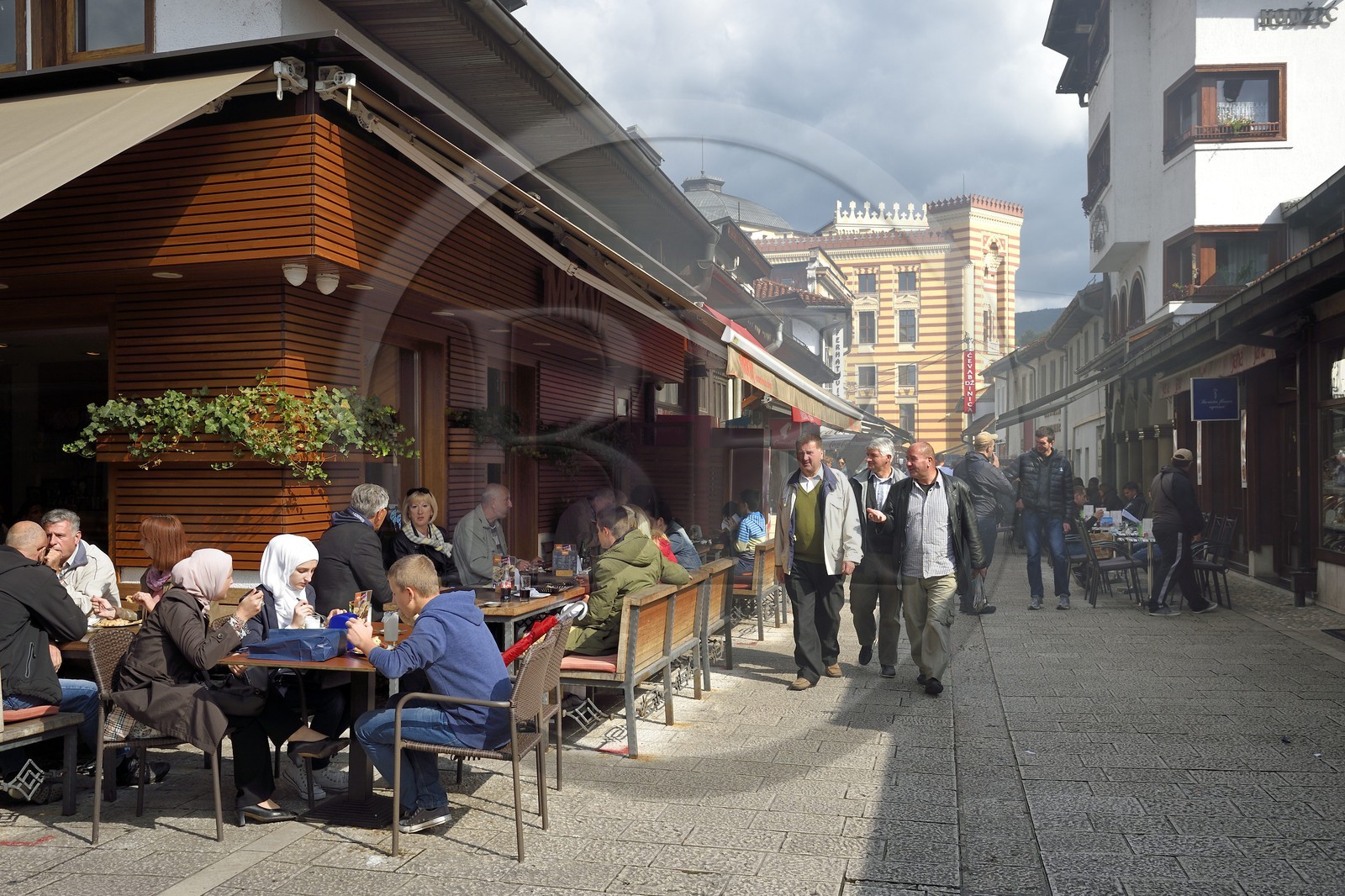 Bosnia and Herzegovina, Sarajevo, Bascarsija district in the old town, Bravadziluk street famous for its Burek and cevapi, the National and University Library in the backgroundrestaurants