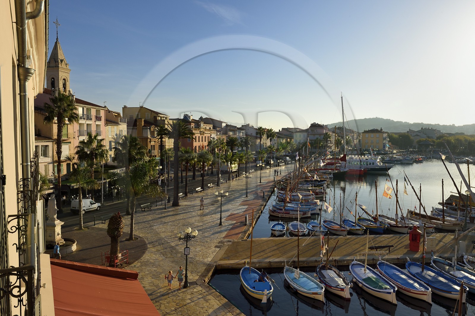 France, Var, Sanary-sur-Mer, traditional fishing boats called pointus in the port and St. Nazaire Church