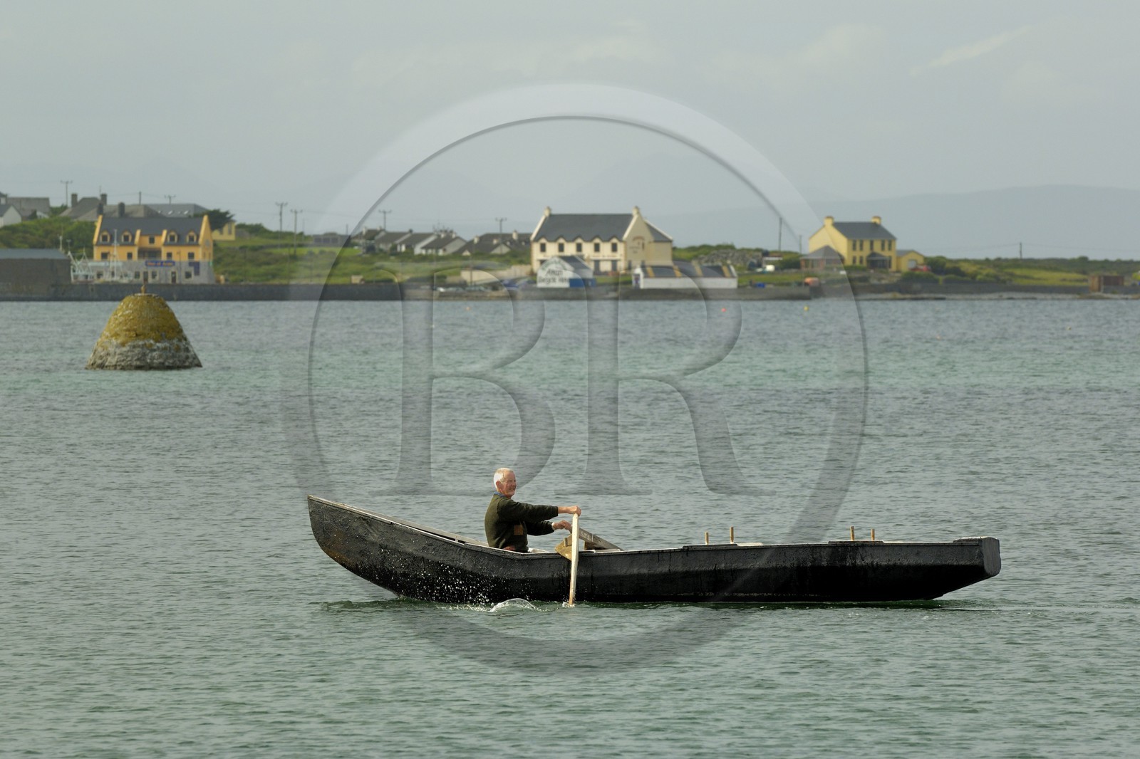 Republic of Ireland, County Galway, Aran Islands, Inishmore, Killeany Bay, curragh (traditional wooden boat with tarpaulin)
