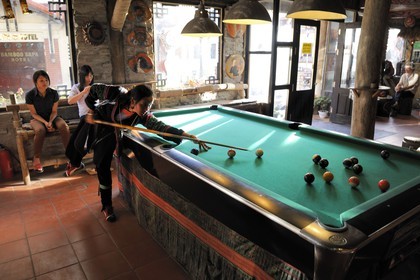 Vietnam, Lao Cai province, city of Sapa, young women from Black Hmong minority group playing pool