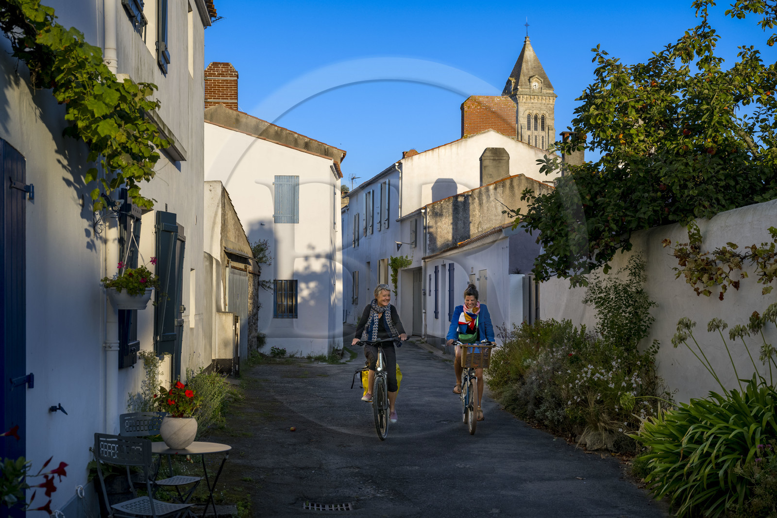 France, Vendée, Noirmoutier island, Noirmoutier en l’Ile, cyclists in the small streets