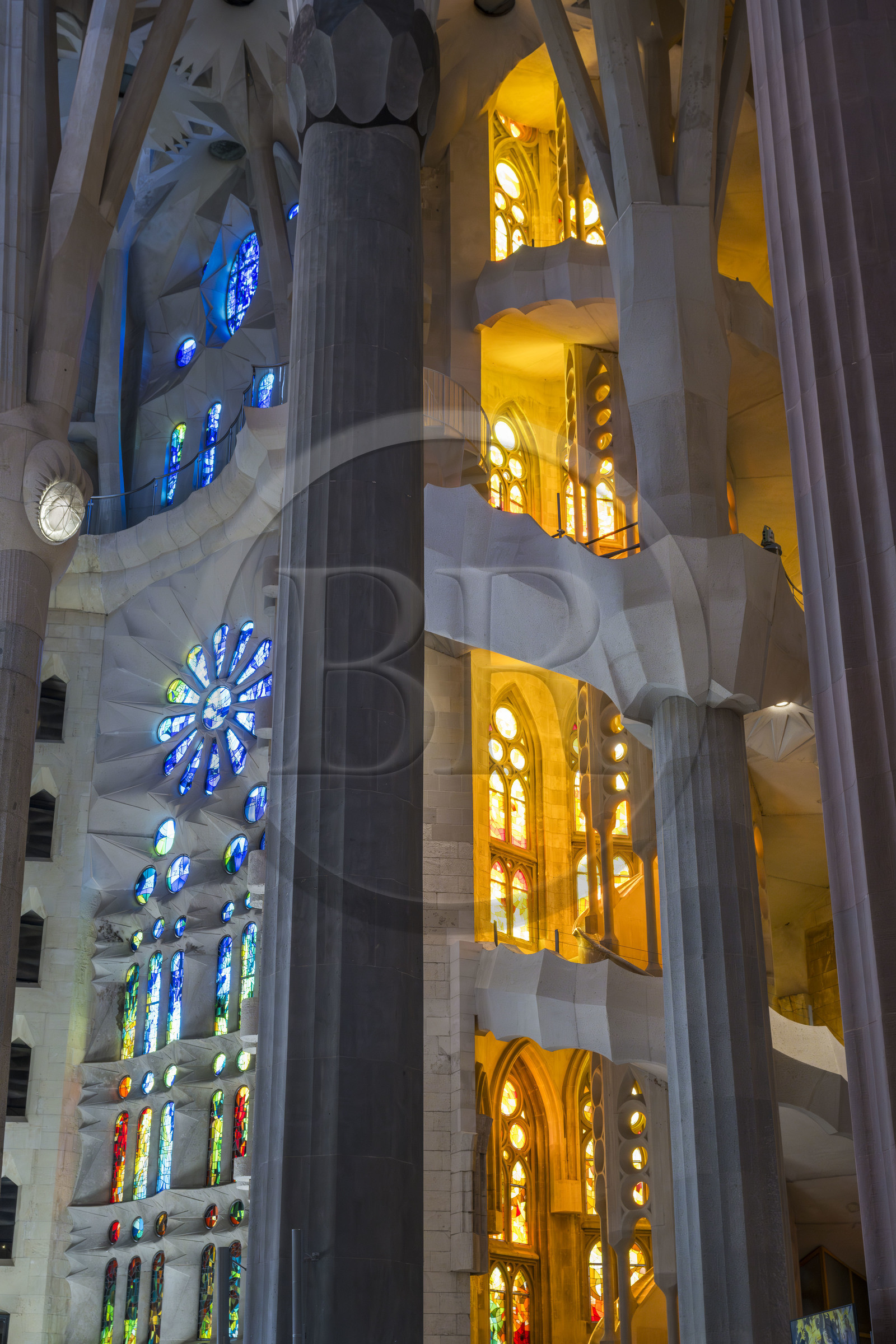 Spain, Catalonia, Barcelona, Eixample district, Sagrada Familia basilica by Catalan modernist architect Antoni Gaudi, listed as a UNESCO World Heritage Site, the transept of the Passion facade dedicated to water, resurrection and light and on the right one of the two spiral staircases of the ambulatory giving access to the upper part of the choir