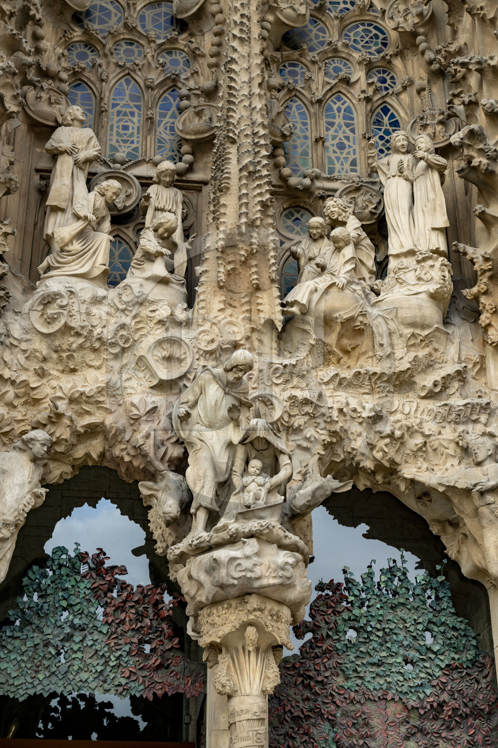 Spain, Catalonia, Barcelona, Eixample district, Sagrada Familia basilica by Catalan modernist architect Antoni Gaudi, listed as a UNESCO World Heritage Site, facade of the Nativity, the Charity Gate, the mother of God and Saint Joseph with Jesus just born