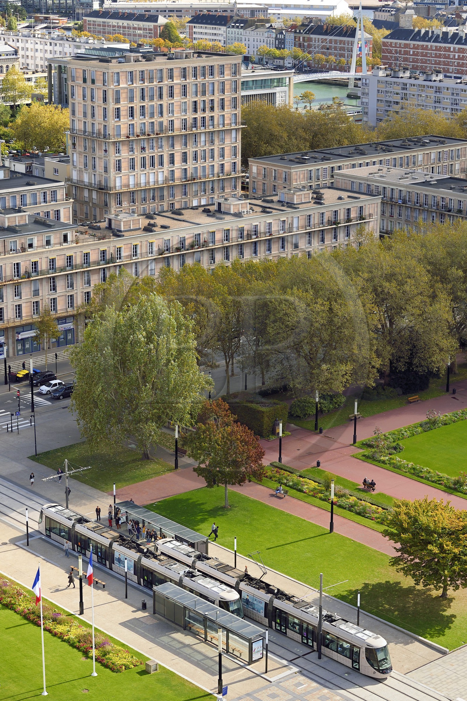 France, Seine Maritime, Le Havre, Downtown rebuilt by Auguste Perret listed as World Heritage by UNESCO, trams on the square in front of the City Hall and the footbridge of the Bassin du Commerce in the background