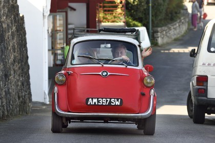 France, Pyrenees Atlantiques, Basque Country coast, Guethary, French journalist, writer and director Alain Gardinier driving his BMW Isetta