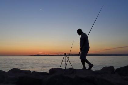 France, Bouches du Rhone, Marseille, La Madrague, fisherman at the sunset facing the Frioul