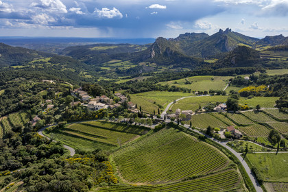 France, Vaucluse, Dentelles de Montmirail mountains, the terraced vineyard surrounding the village of Suzette, the Clapis extended by the Grand Montmirail on the left, the Dentelles Sarrasines in the center and the Grand Travers on the far right (aerial view)