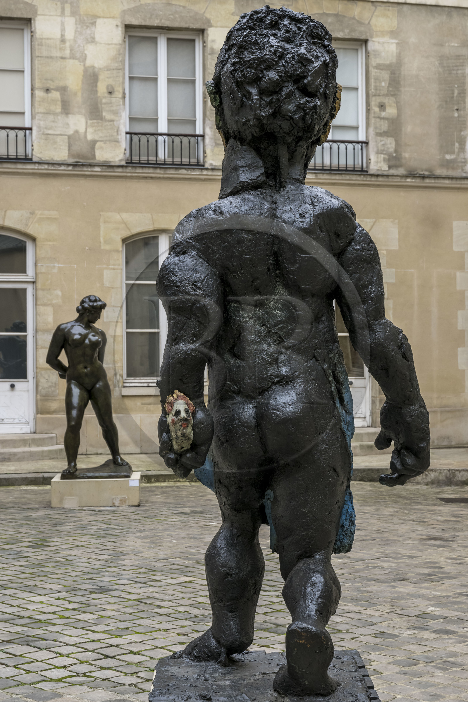 France, Paris, Musée Maillol art museum, sculpture Der Morgen oder Hölderlin, 2011, Painted bronze by the artist Markus Lüpertz, sculpture by Aristide Maillol, Chained Action, 1905, bronze in the background