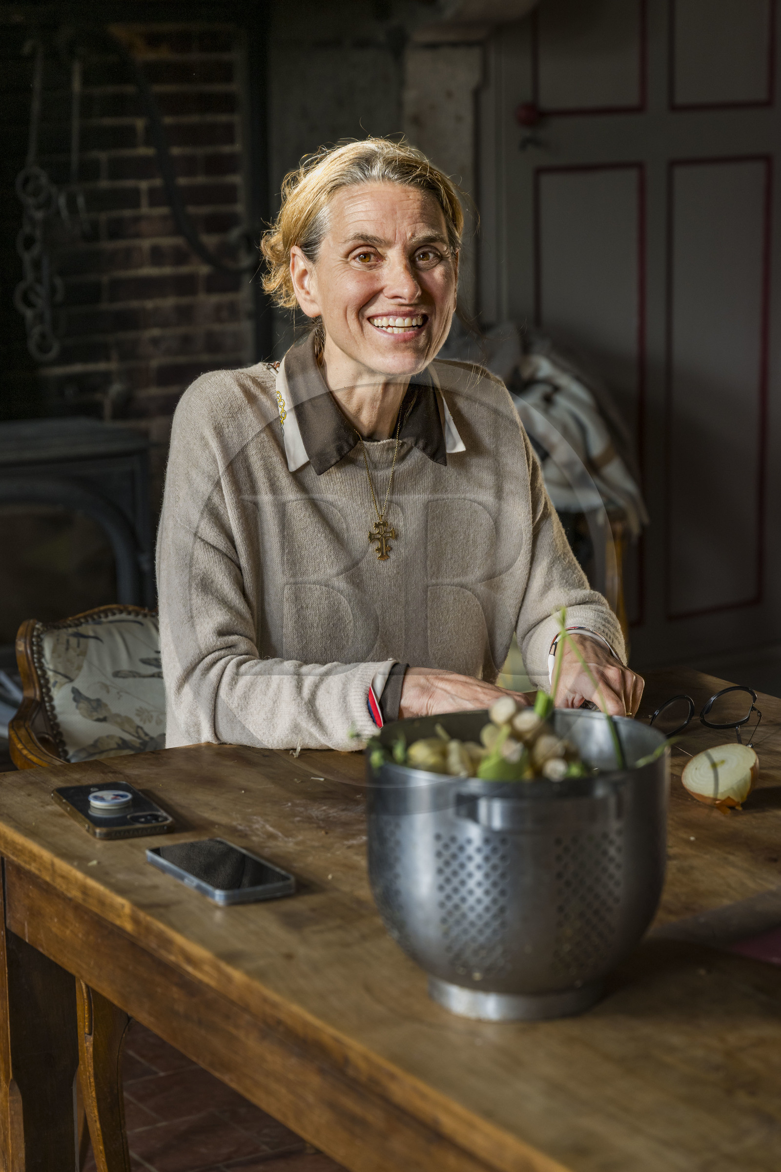 France, Vendee, Sèvremont, the Château de la Flocellière, gite and guest room, chatelaine Sandrine Vignial preparing dinner for her guests in the kitchen