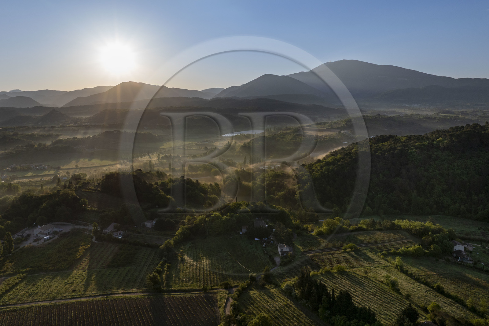 France, Vaucluse, Dentelles de Montmirail mountains, Crestet, the plain north of Malaucène at sunrise and Mont Ventoux in the background (aerial view)