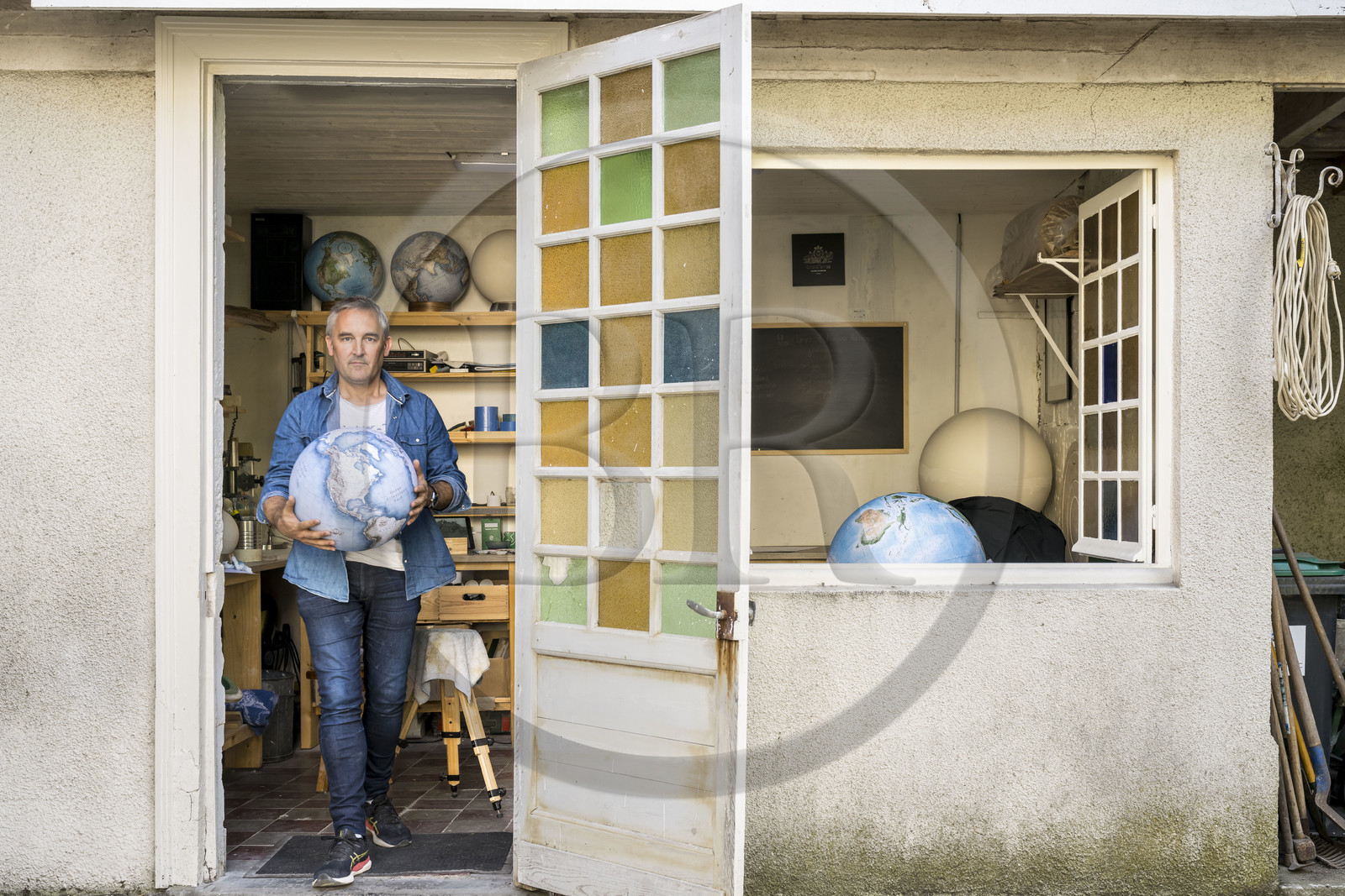 France, Charente, Cognac, Gabriel Gaborel, creator of OrbisTerrae, manufactures handcrafted terrestrial globes painted in watercolor