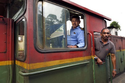Sri Lanka, Uva Province, the popular scenic train ride through the tea growing hill country between Hatton and Badulla, engine driver and his assistant