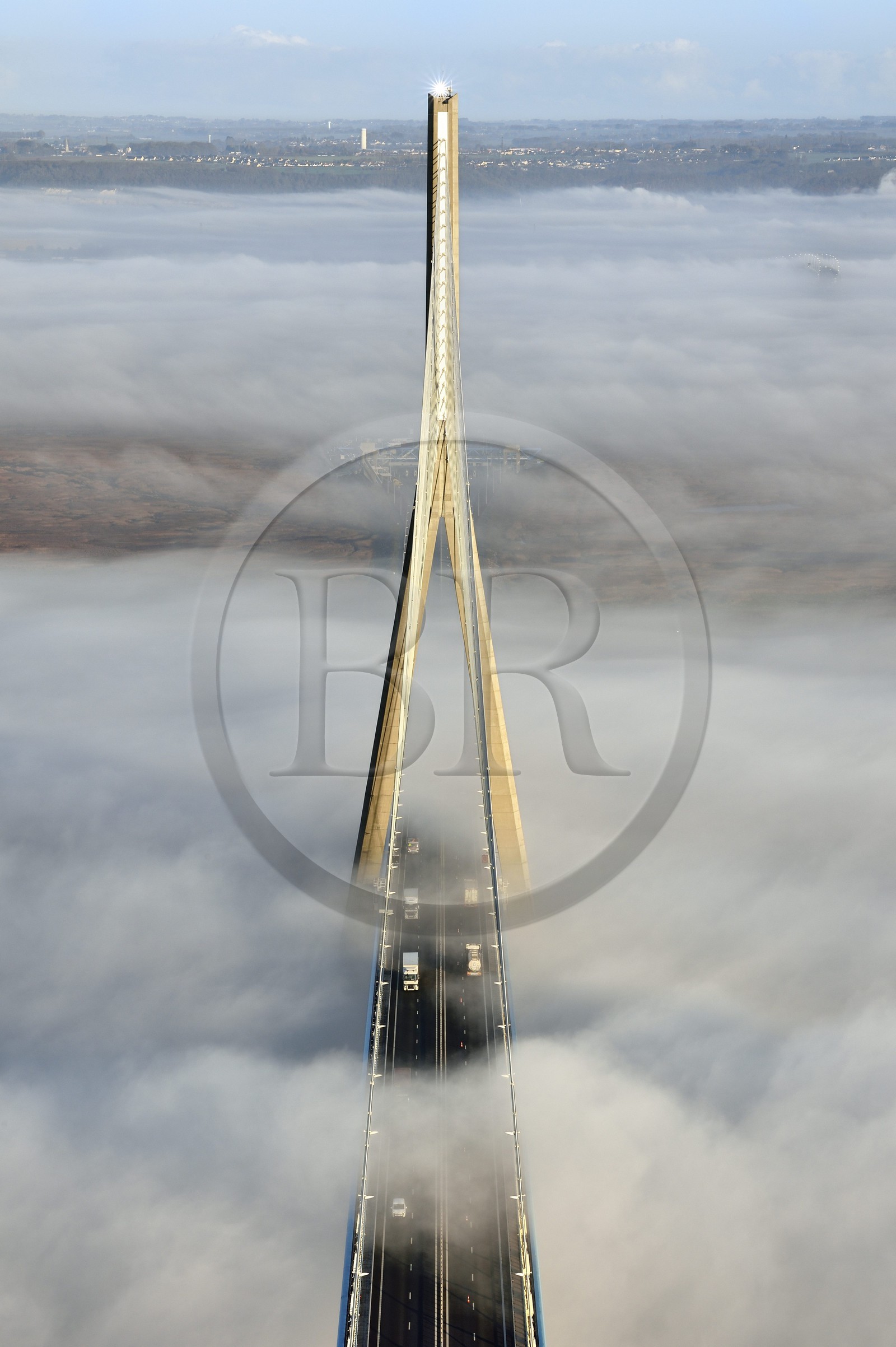 France, between  Calvados and Seine Maritime, the Pont de Normandie (Normandy Bridge) that emerges from the morning mist of autumn and spans the Seine, view from the top of the south pylon