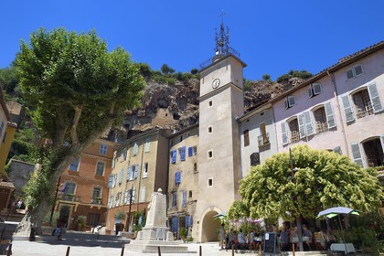 France, Var, Provence Verte, Cotignac, the Town Hall Square and the Clock tower below the tufa cliff of 80 meters high and 400 meters wide