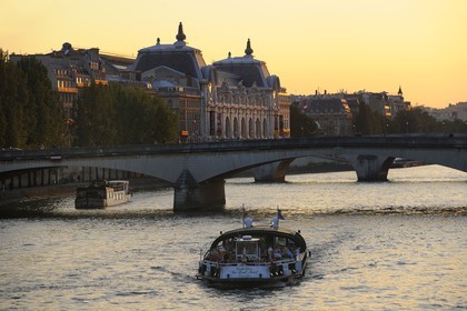 France, Paris, the Seine river banks listed as World Heritage by UNESCO, boat in front of the Pont du Carrousel and the National Museum of Orsay, housed in the old Gare d'Orsay (1898)