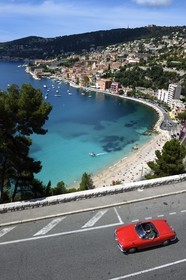 France, Alpes-Maritimes, Villefranche-sur-Mer, collection convertible Alfa Romeo Giulietta on the Basse Corniche road overlooking the city