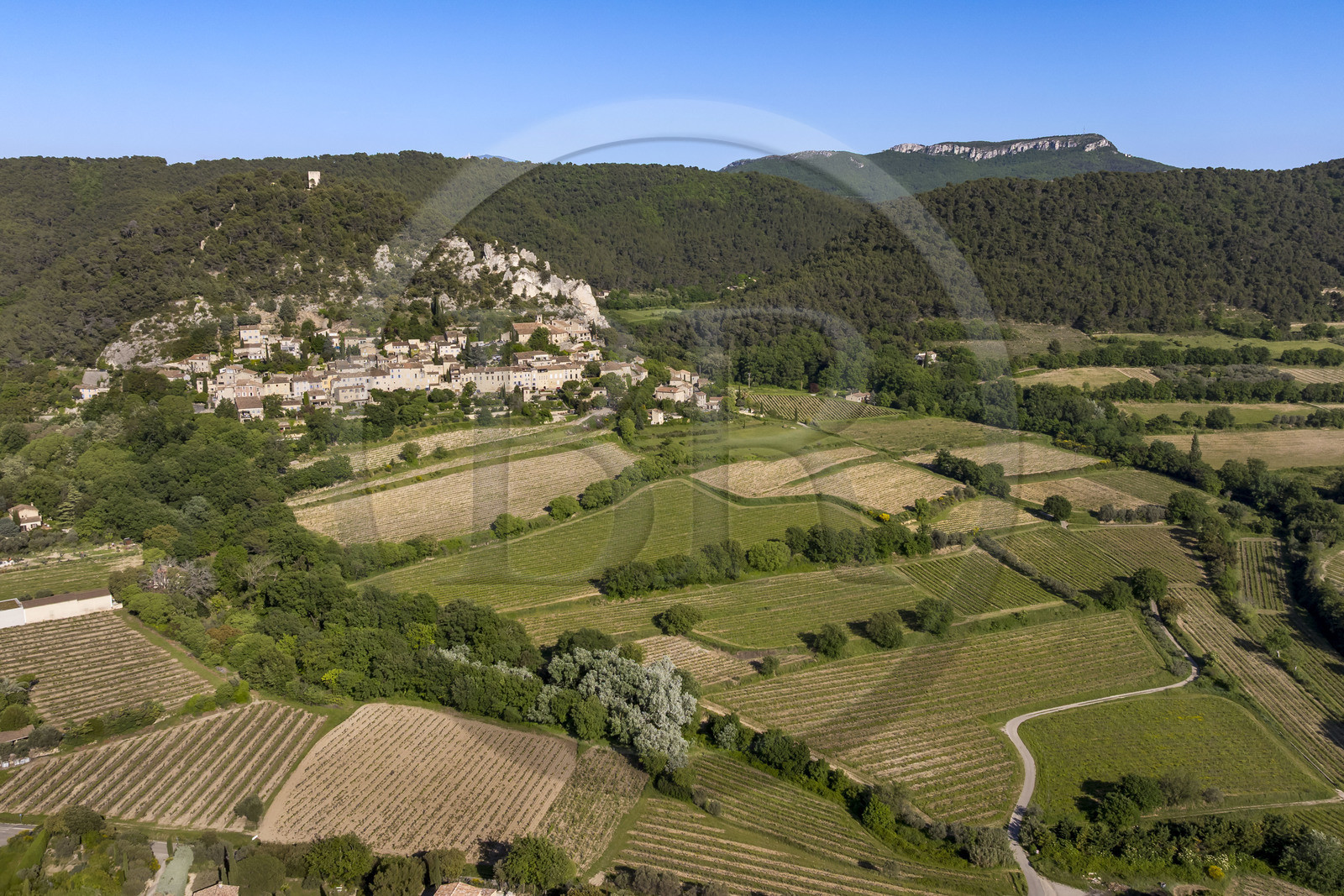 France, Vaucluse, Dentelles de Montmirail mountains, the medieval village of Séguret, labelled Les Plus Beaux Villages de France (The Most Beautiful Villages of France), and the Saint-Amand ridge seen from the south in the background (aerial view)