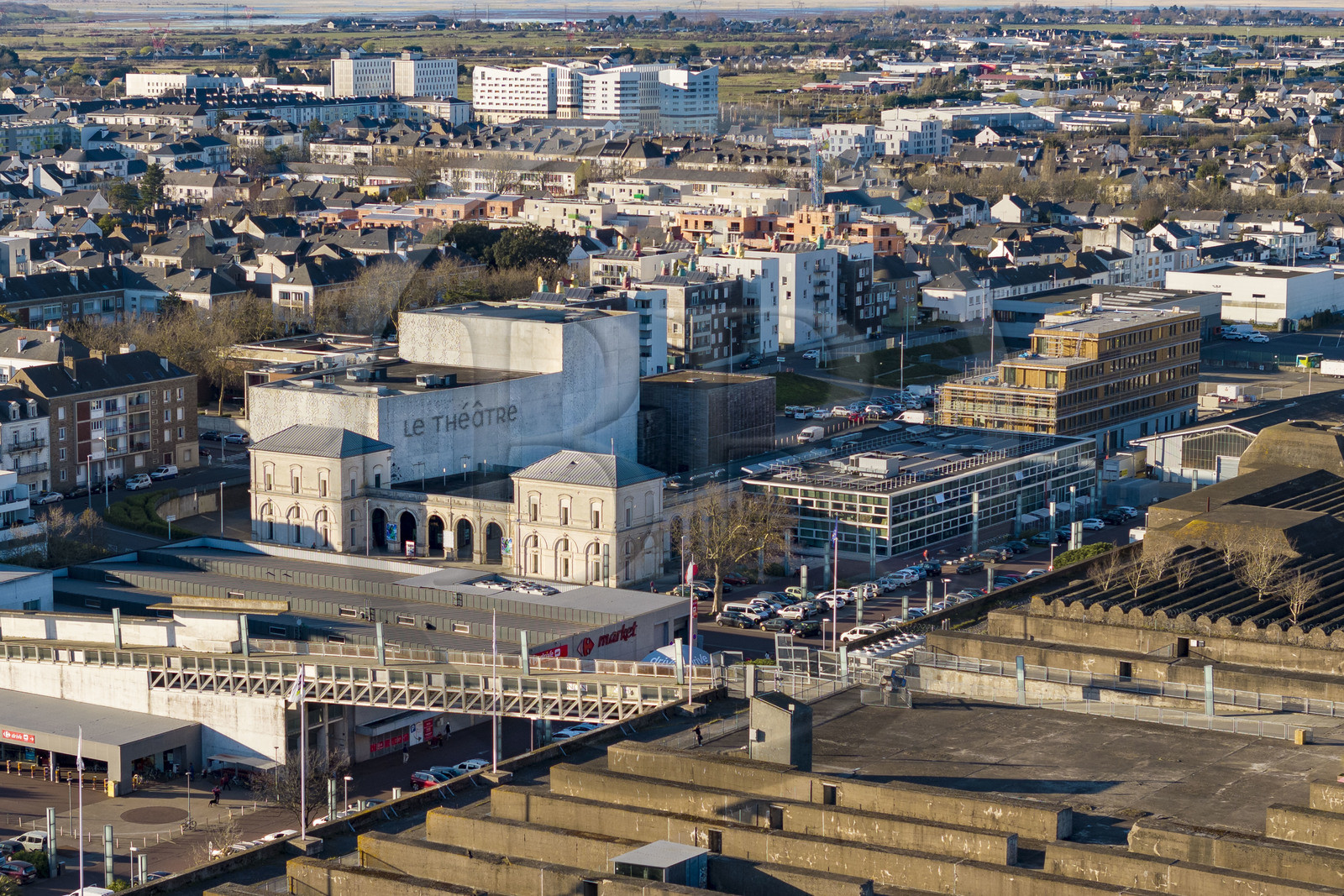 France, Loire-Atlantique, Saint-Nazaire, the Simone-Veil Theatre, national stage, designed by Karine Herman of the K-architectures agency in the city's bombed-out former train station, the roof of the submarine base in the foreground (aerial view)