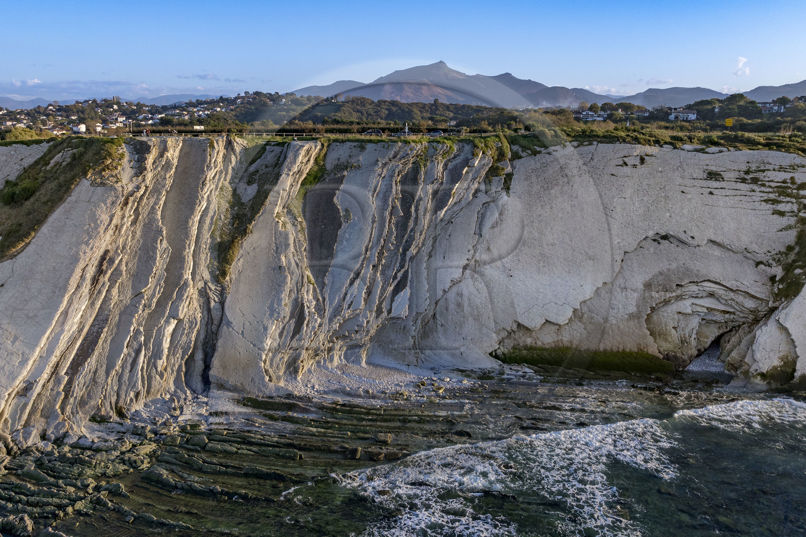 France, Pyrenees Atlantiques, Basque Country coast, the Basque Corniche, Urrugne, the Atlantic coast towards Socoa, flysch cliffs and La Rhune mountain in the background (aerial view)