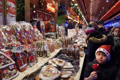France, Bas Rhin, Strasbourg, old town listed as World Heritage by UNESCO, Christmas market (Christkindelsmarik) on the place Broglie, child eating a Candy apple