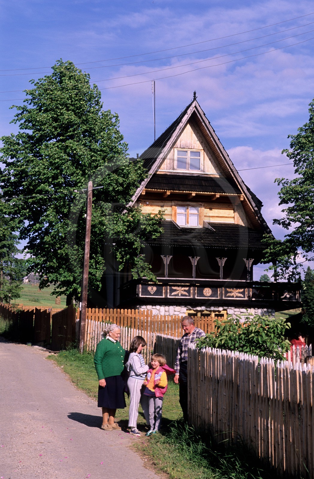 Poland, Lesser Poland, Carpathian Mountains, Zarcopane area, family of farmers in front of their wooden house
