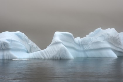Greenland, west coast, Disko Island, iceberg in the mist off Qeqertarsuaq