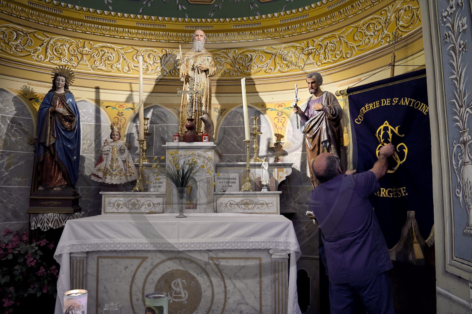 France, Corse du Sud, Cargese, catholic church (latin rite) built in the 19th century, statue of St. Anthony and the banner of his brotherhood