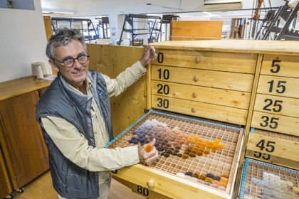 France, Herault, Lodève, Manufacture de la Savonnerie (Savonnerie manufactory) unique annex of the National Carpet Factory of the Savonnerie des Gobelins in Paris, site director Jean-Marc Sauvier devant le nuancier NIMES qui contient les pompons de laine échantillons